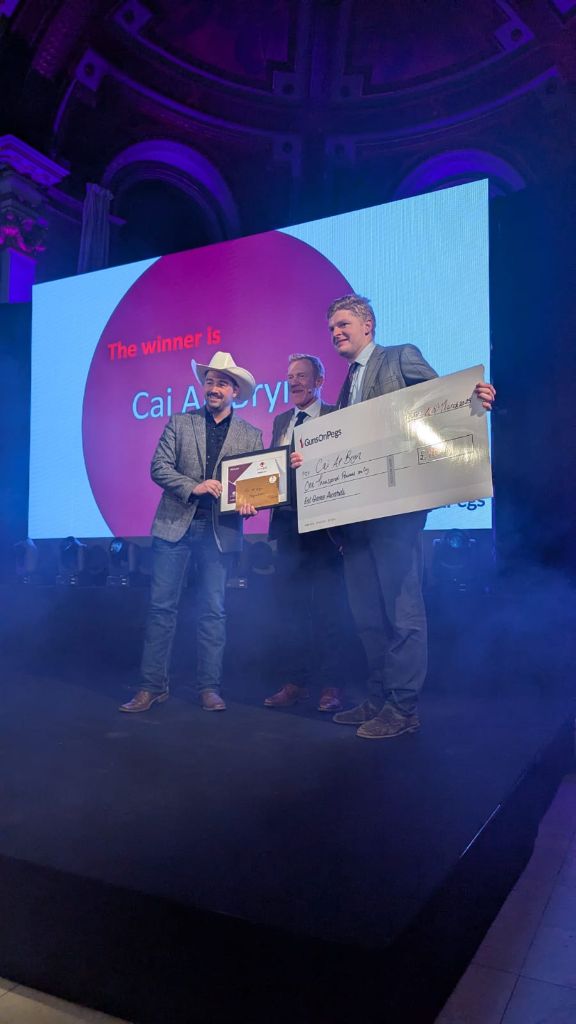 Cai Ap Bryn receiving award on stage at Eat Game Awards with cheque