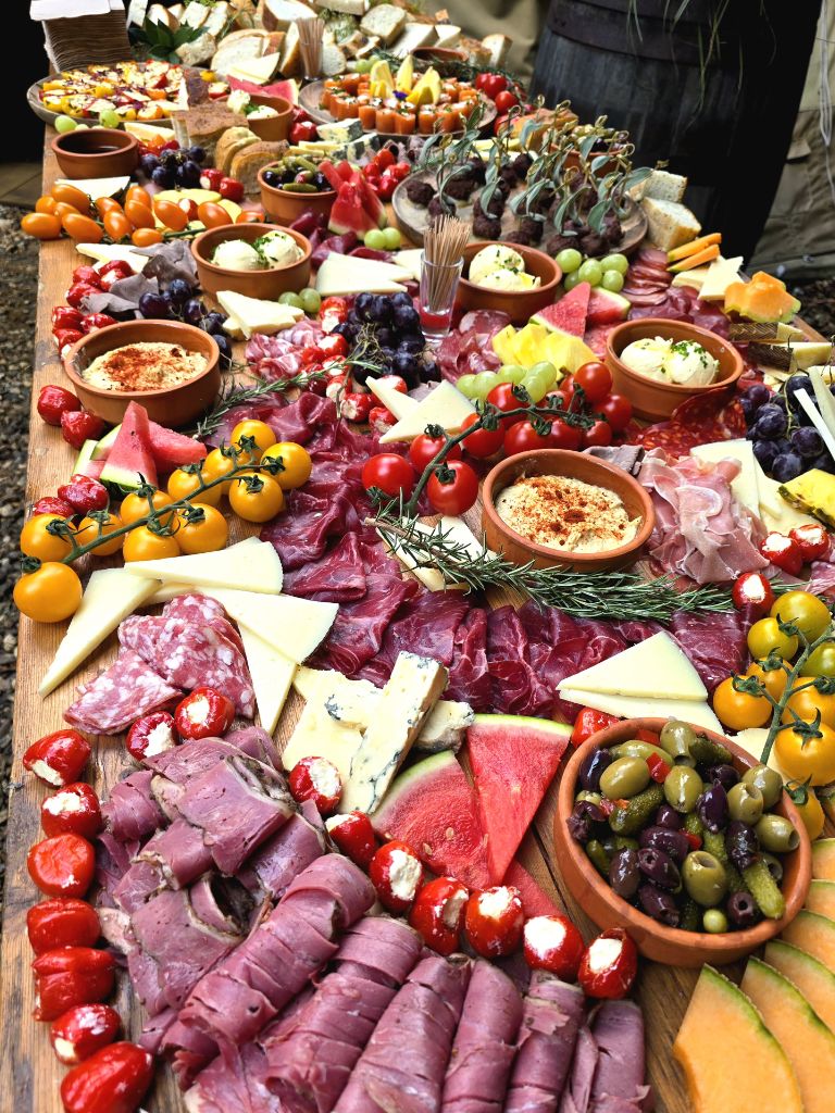 A festive corporate grazing table and fire-cooked spread laid out for a company Christmas celebration