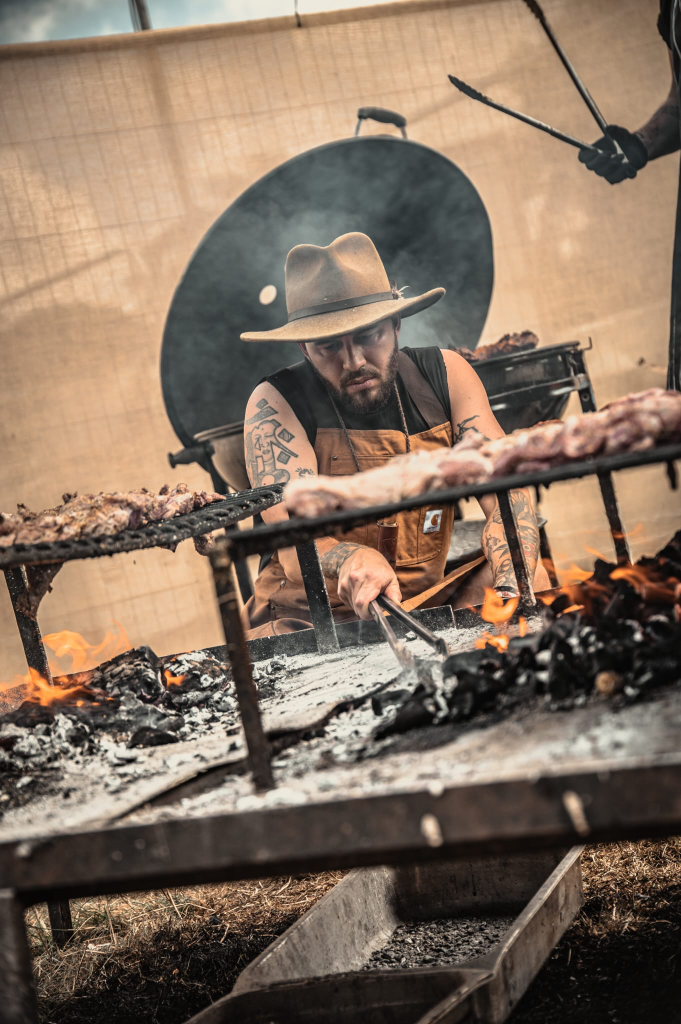 Chef Cai Ap Bryn working the live fire grill at a corporate event