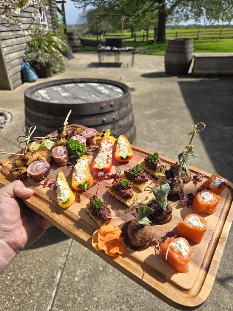 Canape board with fire-cooked wild game bites and smoked salmon
