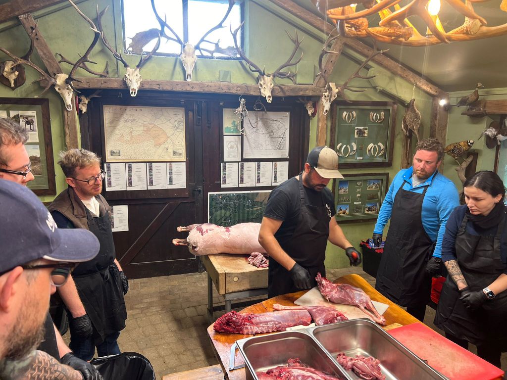 Learning to prepare venison at a workshop
